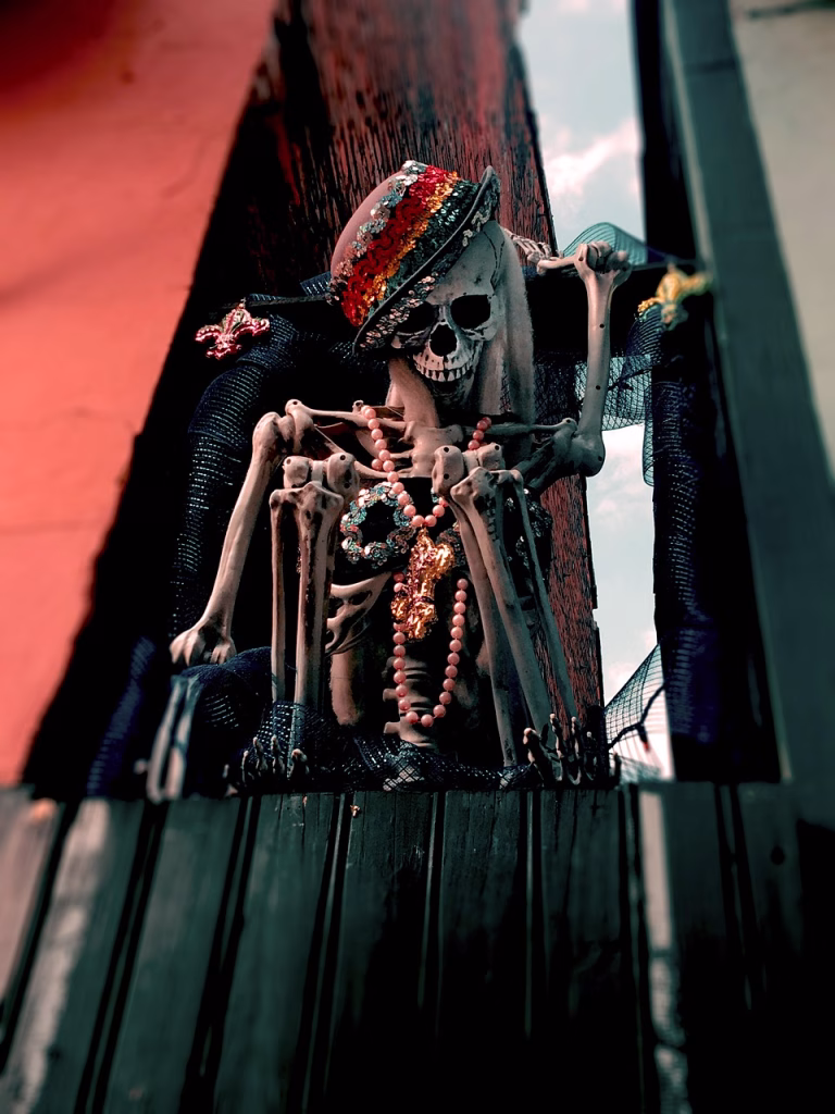 skeleton with beads and sequined hat in a nook between buildings in new orleans